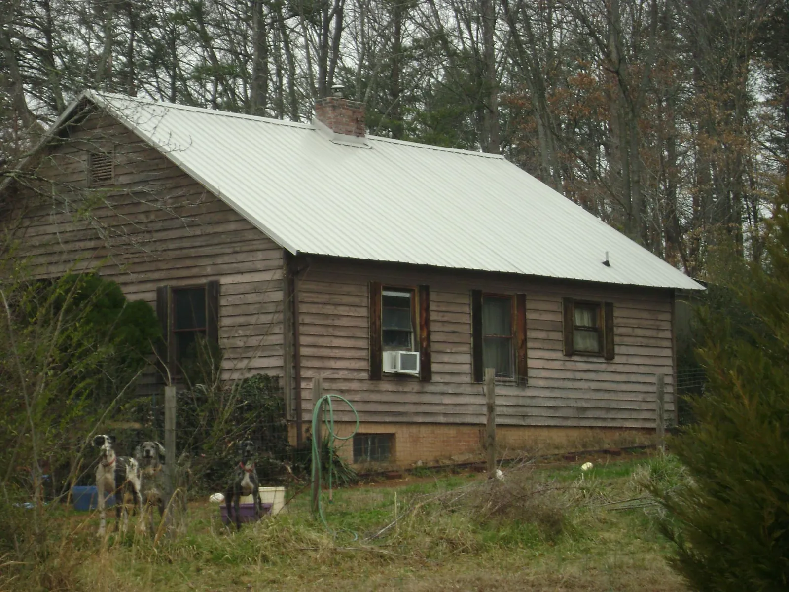 White metal roof on an old wood sided farmhouse, from a Metal Roof Installation job in North Windham